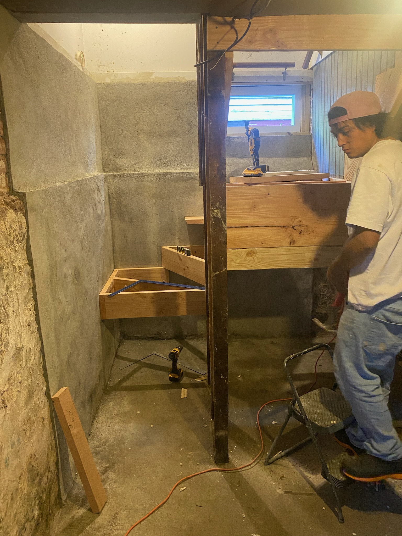 Worker constructing basement stairs