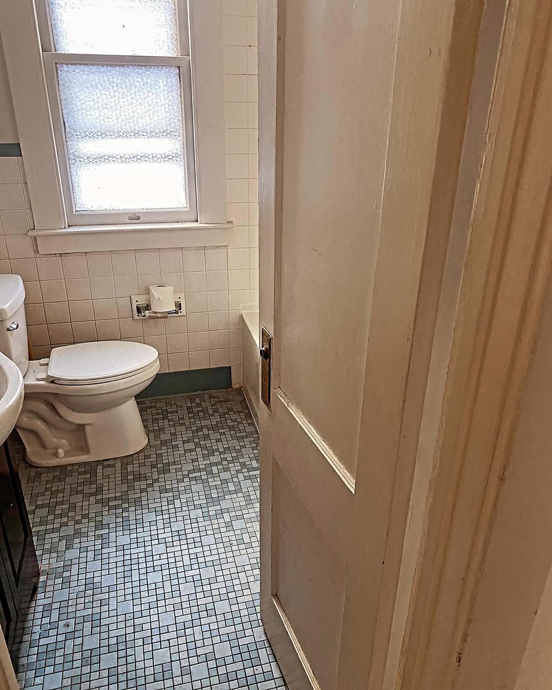Original bathroom with old blue hex tile and dated fixtures