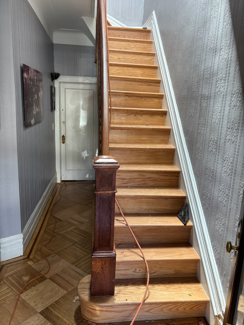 Beautifully restored original hardwood staircase in historic hallway