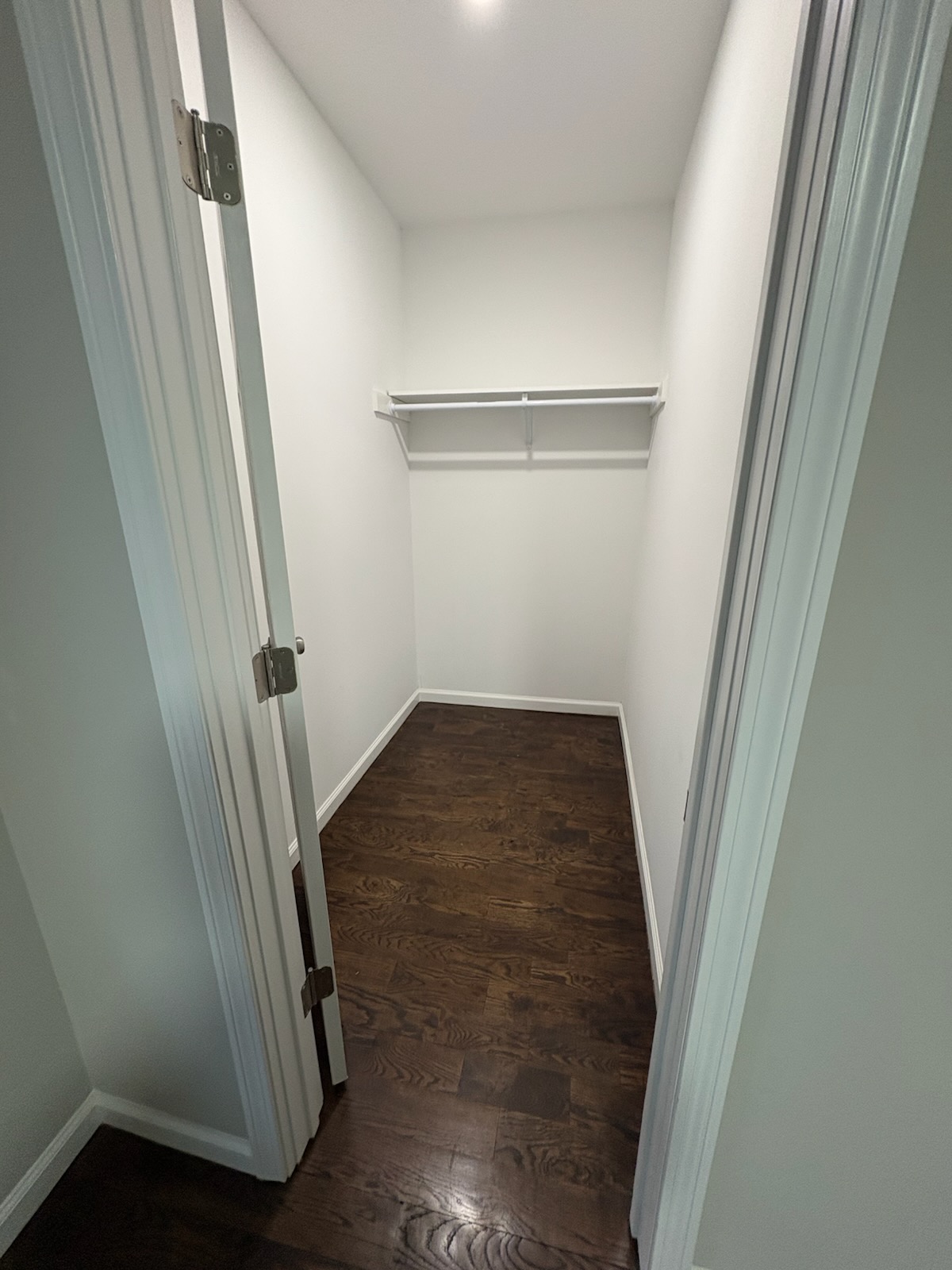 Finished walk-in closet with hardwood floors