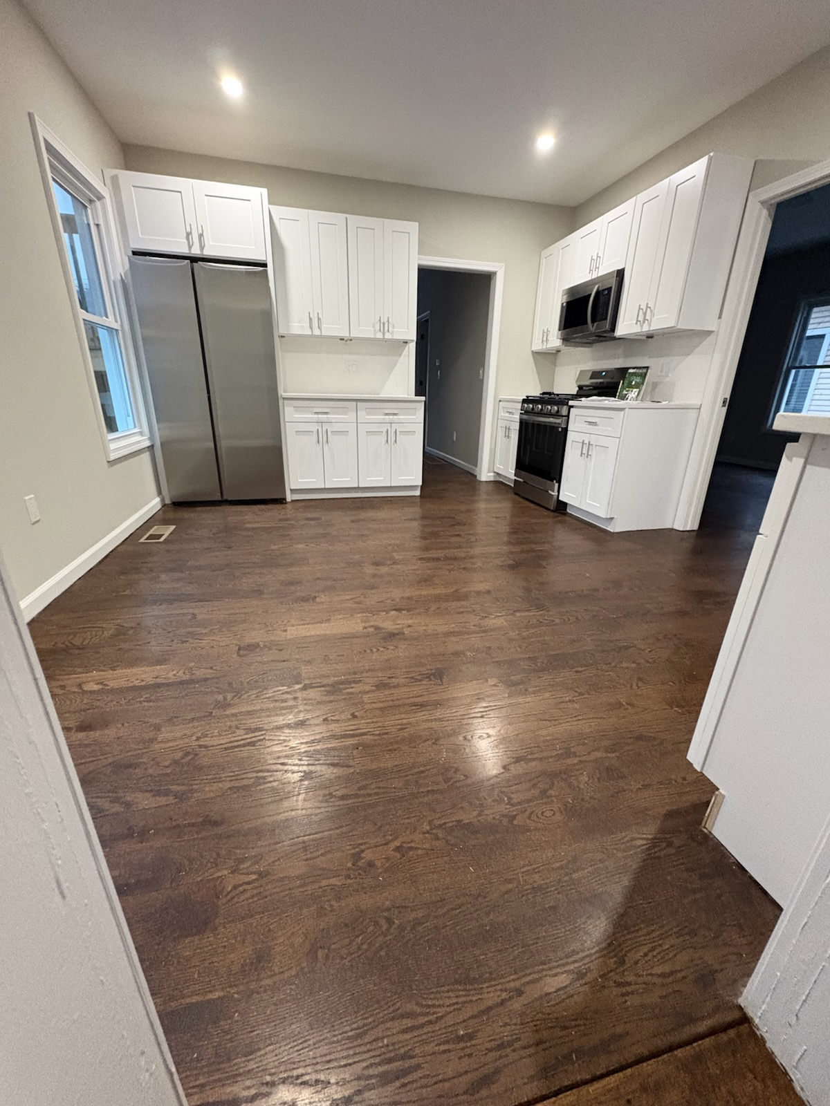 Finished kitchen with stainless appliances and hardwood floors