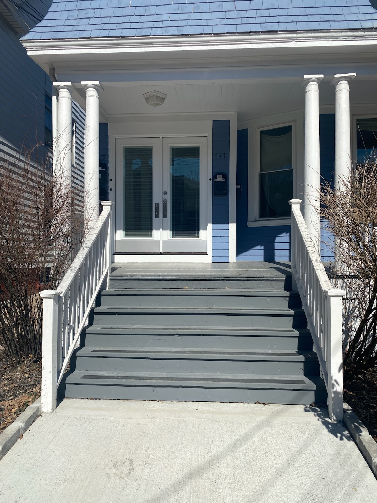 Fully restored front porch with fresh paint and new trim